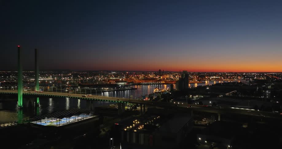 Aerial panorama of a metropolis at night with the red sky on the horizon