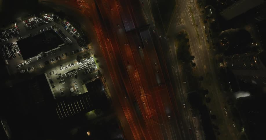 Skyline of an urban highway with calm traffic at night