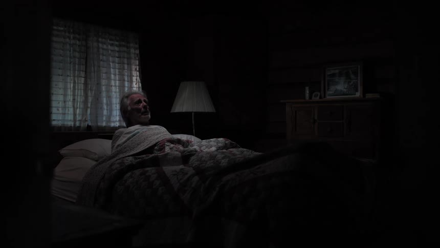 Elderly man sleeping in his room when suddenly outside lights go on and he wakes up in despair