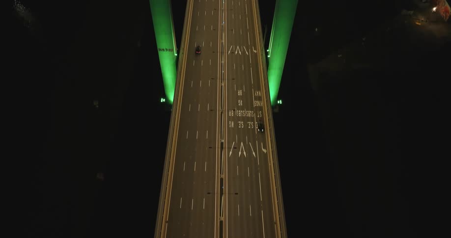 An aerial view of traffic driving on a bridge