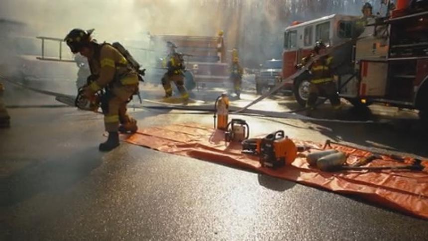 Firefighters ready themselves to fight a fire