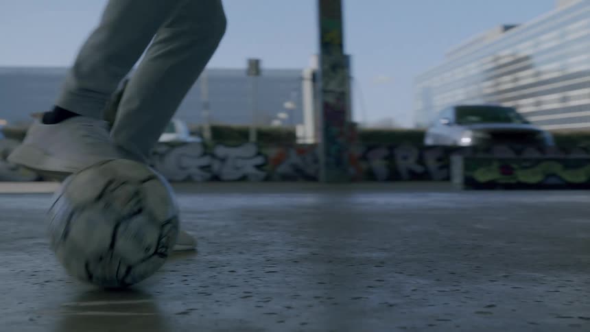 Closeup of a persons legs dribbling like a soccer ball