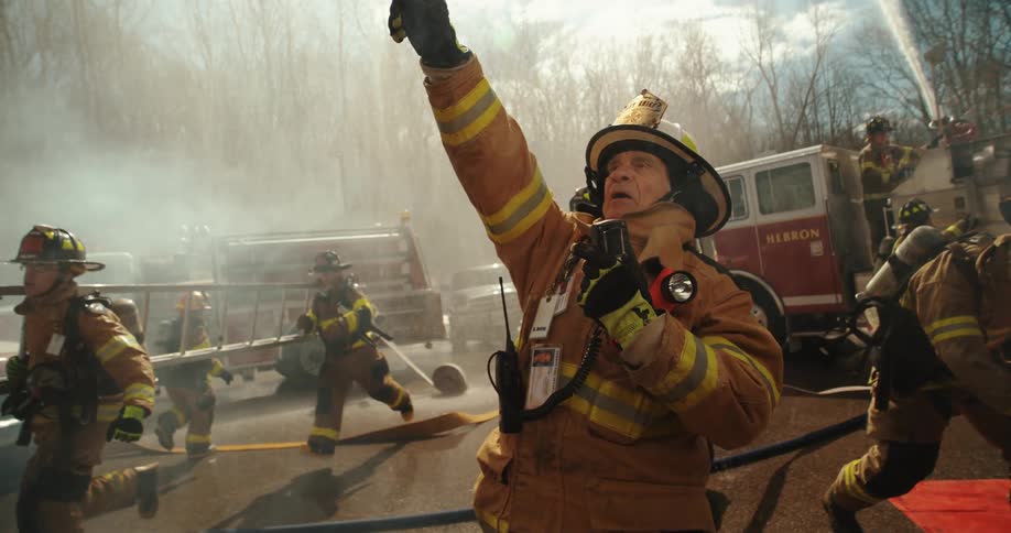 Fire Captain directs action of Firefighters