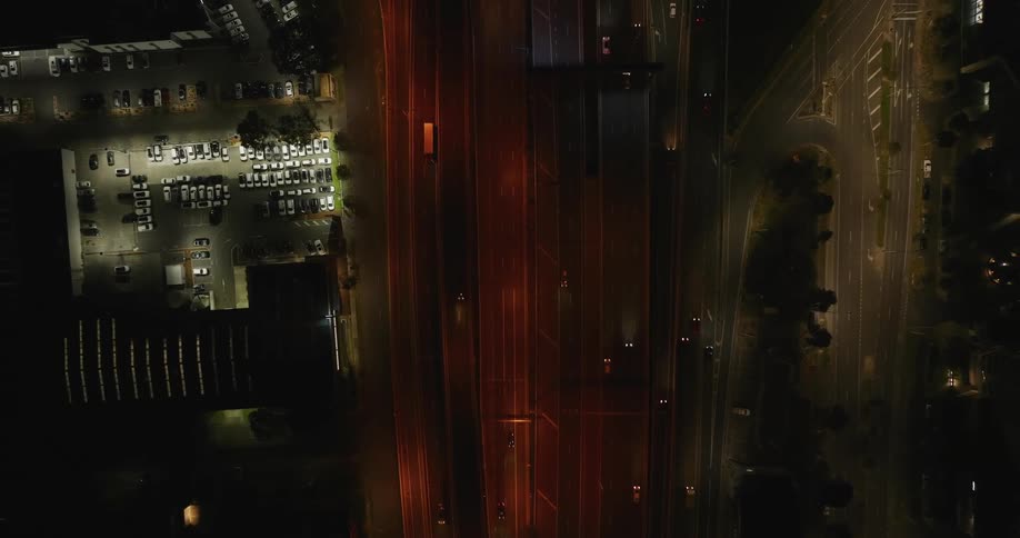 An aerial view of cars driving down a road