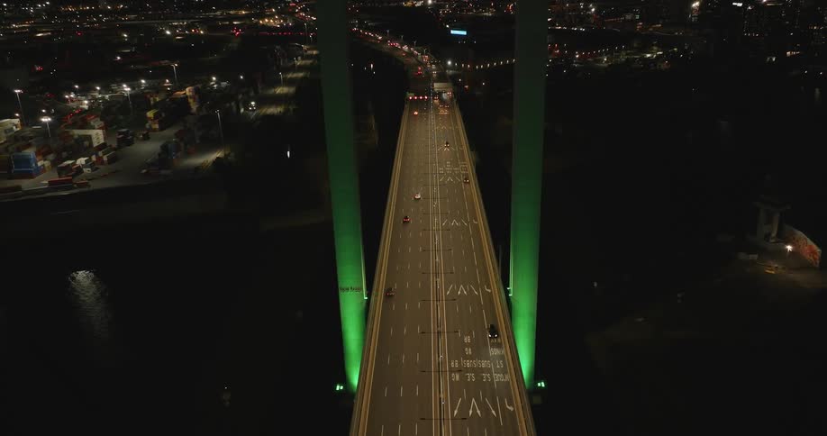 Aerial panorama of a bridge at night with vehicle traffic