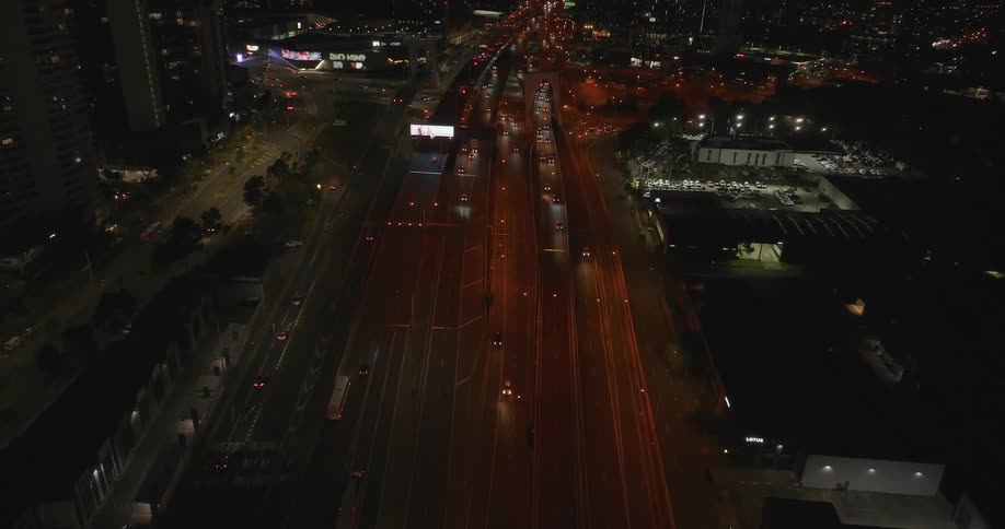 Skyline of a metropolitan city with heavy traffic at night