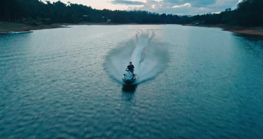 A man races his jet ski down the river