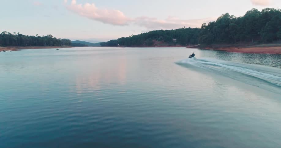 A person races their jet ski in a river