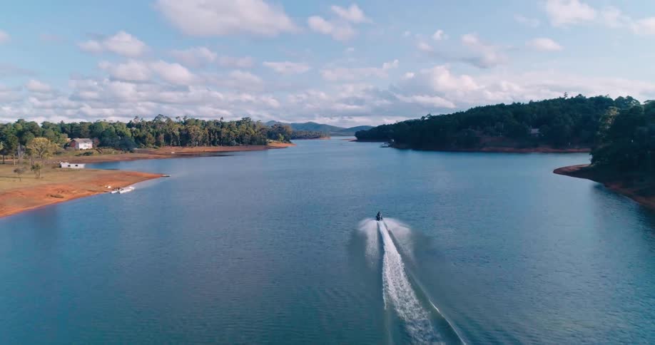 Jet ski at high speed on a vast lake during the day
