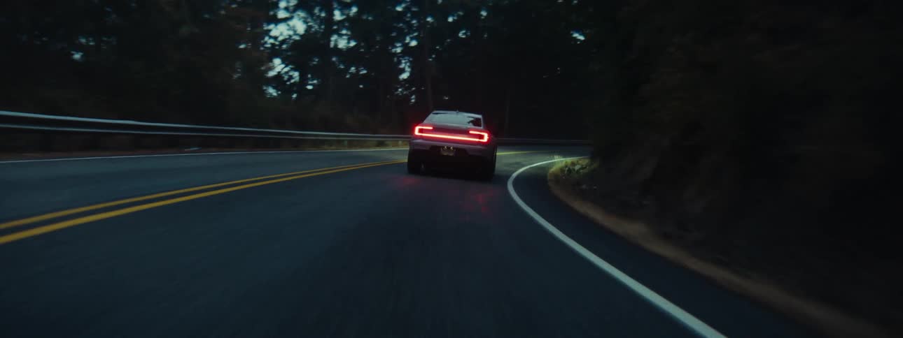 Back of a speeding car on the road at dawn
