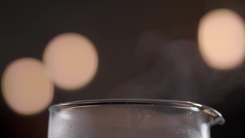 Steam rises off of a glass