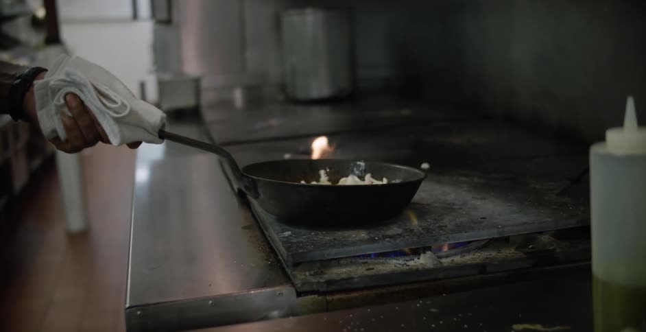 Person frying food on a stovetop
