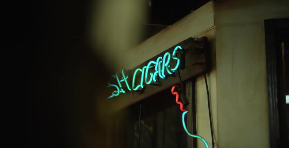 A sign that says "fresh cigars" is illuminated