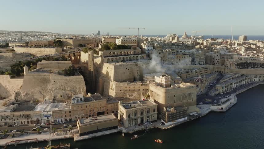 Aerial of a port with boats anchored in a coastal town
