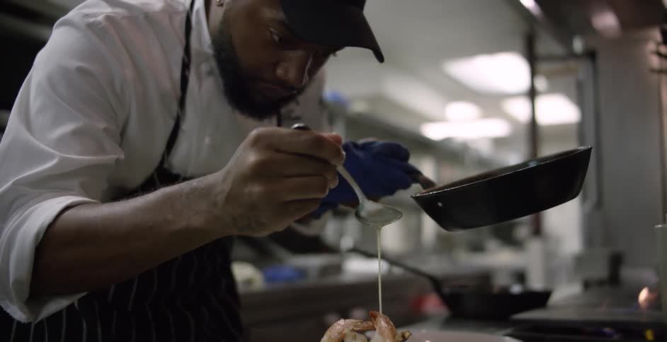 A chef is preparing food in a kitchen