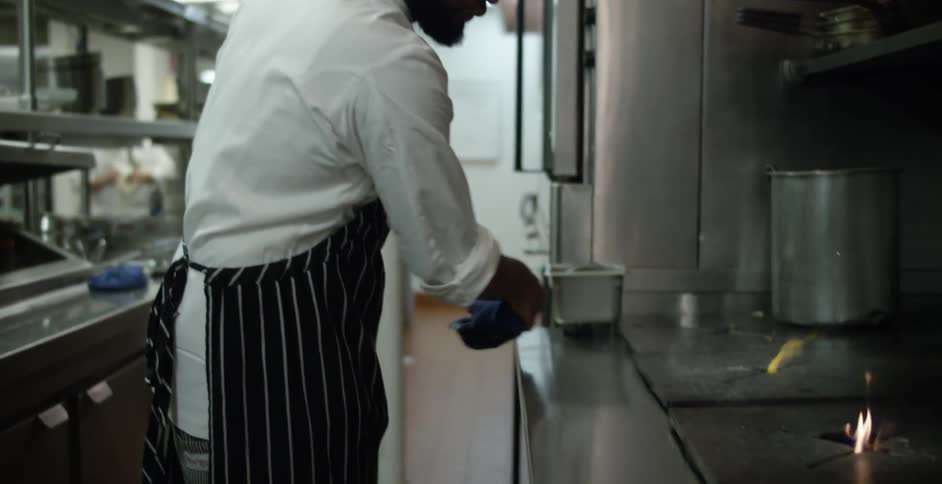 A cook is cleaning his work station