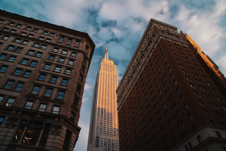 Upward view with big new york buildings on a blue sky day with clouds