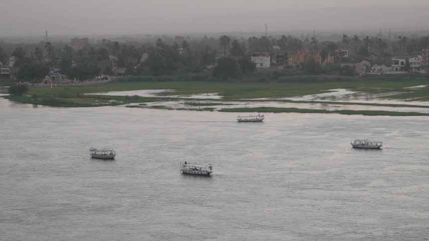 Aerial panorama of tourist boats passing through a canal next to a city