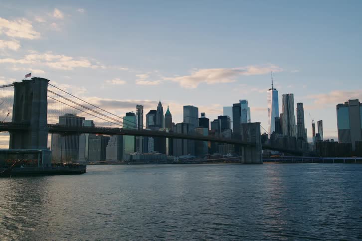 The brooklyn bridge spans across the cityscape connecting bustling neighborhoods