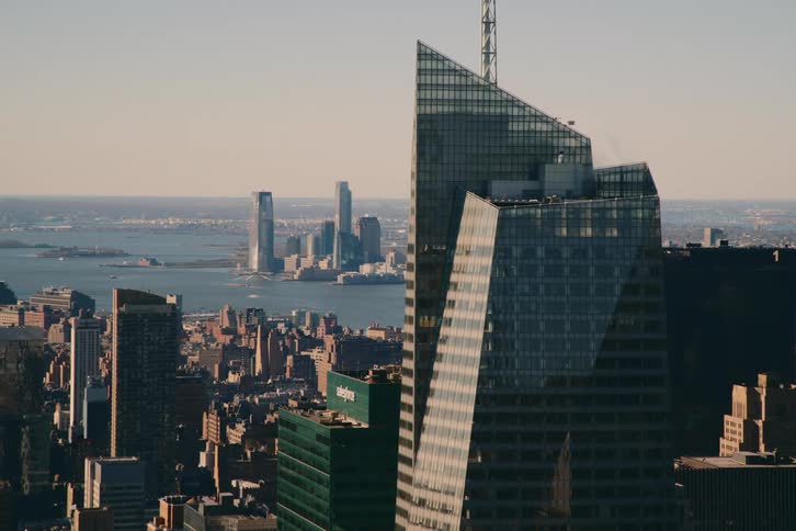 A skyscraper towers over a city skyline