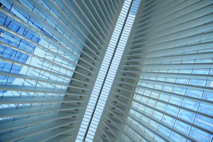 Interior architecture with an upward view of a glass and modern mirrored roof