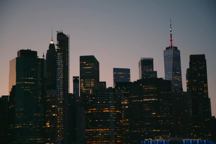 Illuminated tall buildings in the city at dusk