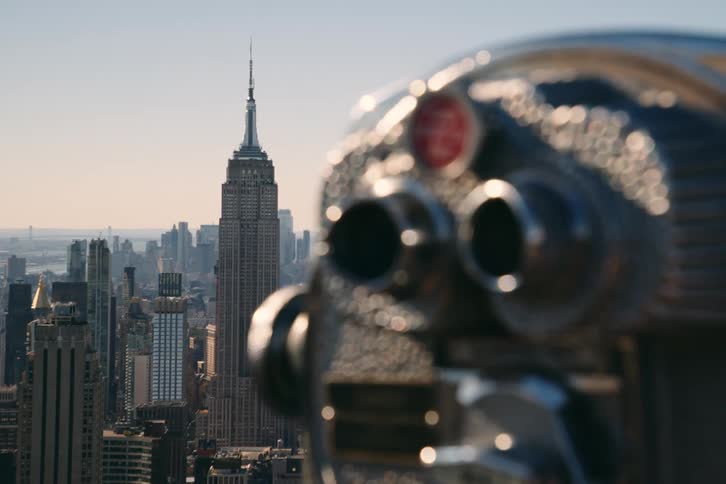 A pair of fix binoculars are aimed in the direction of the empire state building