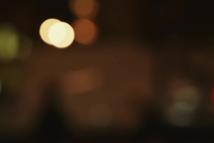 A blurry image of traffic lights at night