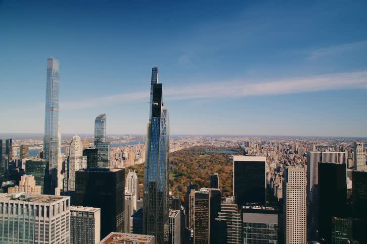 Skyline of skyscrapers in front of central park on a sunny day