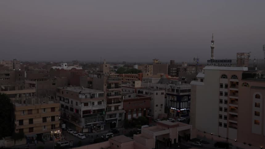 Traffic moves through a dense city