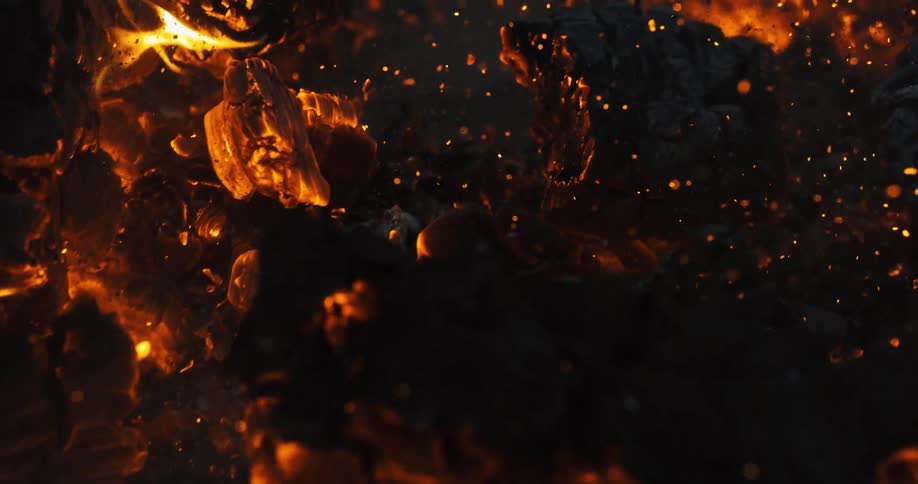 The wind blows burning wood ashes