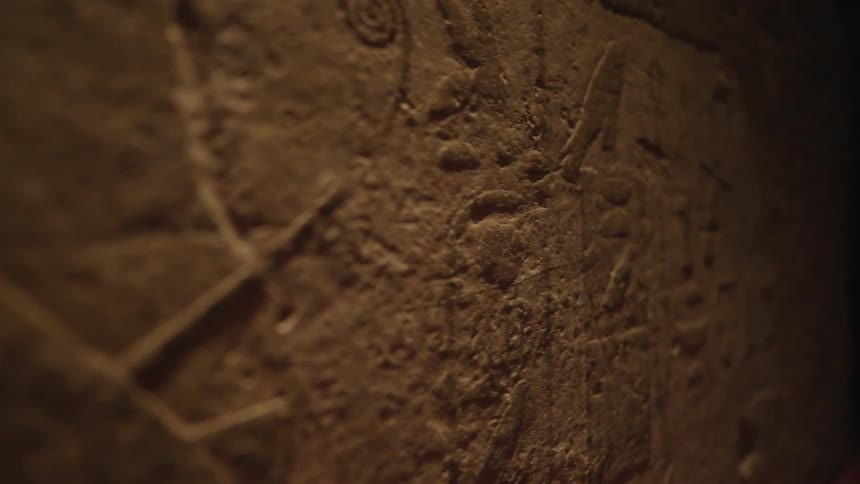 Archaic drawings on a rocky wall of a cave