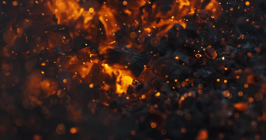 The wind blows burning wood ashes