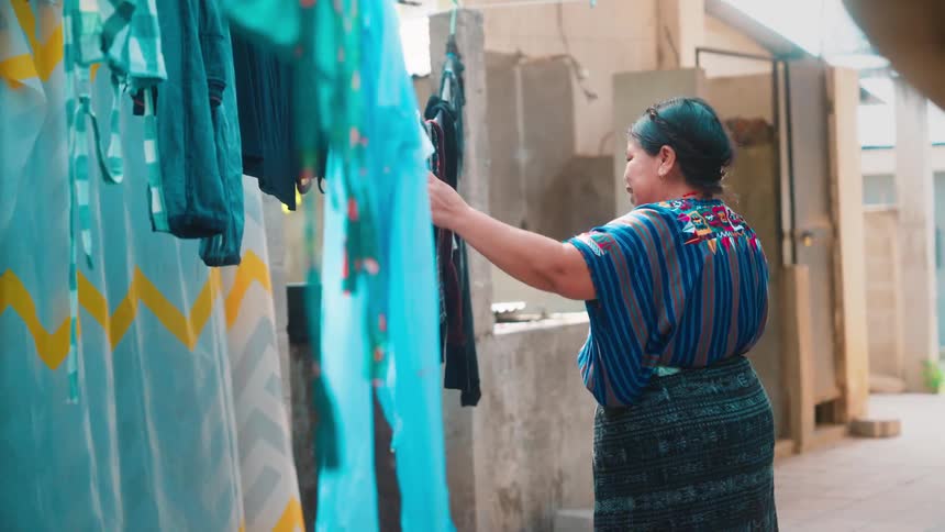 Woman putting clothes on clothesline
