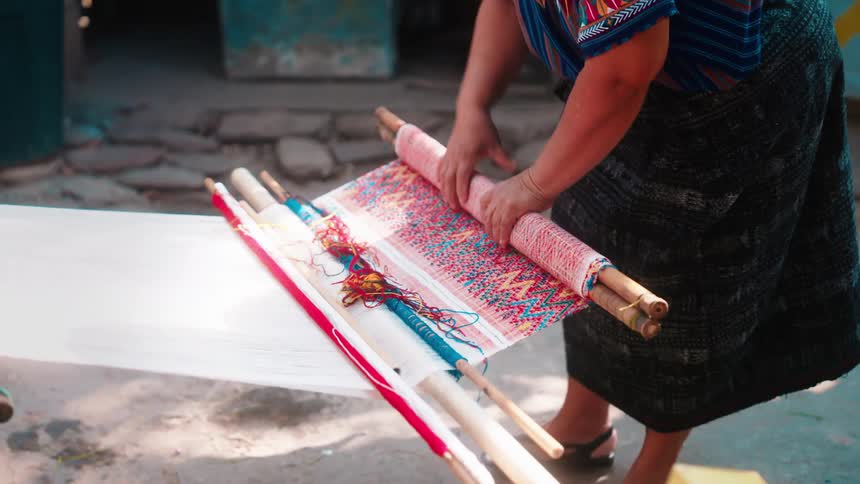 A woman is unrolling fabric