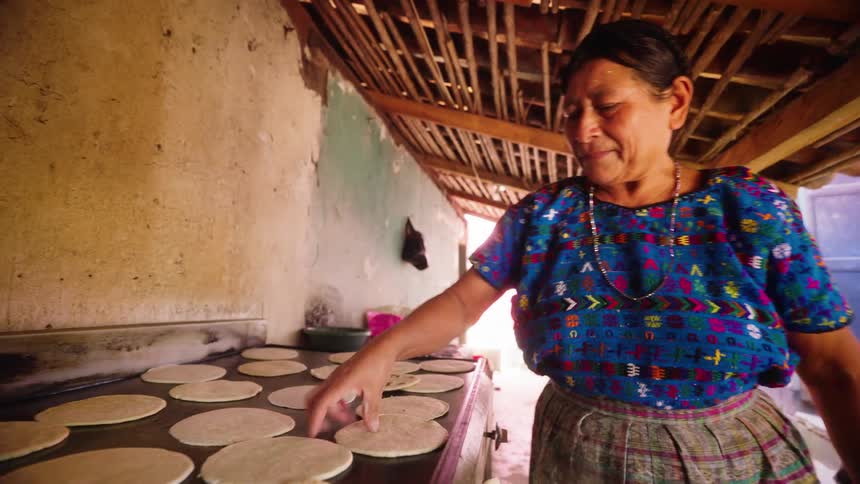 A woman is cooking outside
