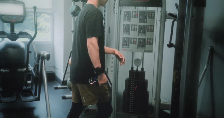 A man in physical rehabilitation search for equipment on a gym