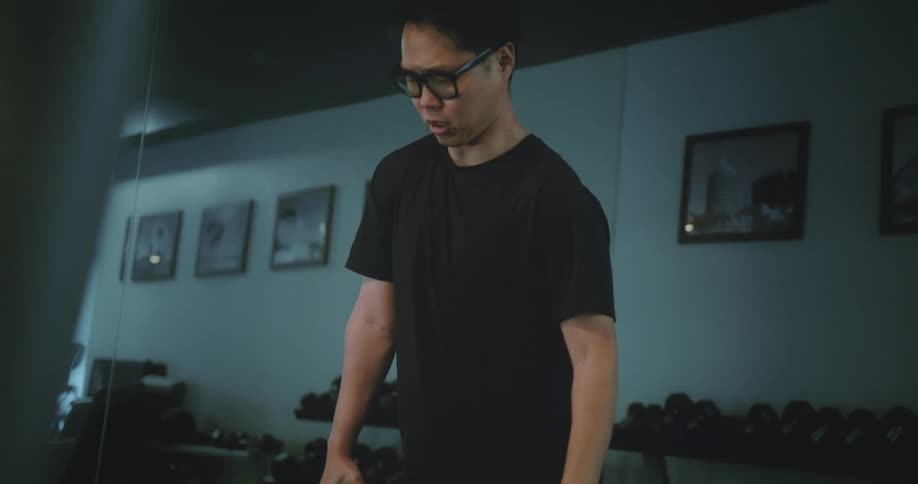 Young man in the gym stretching his body