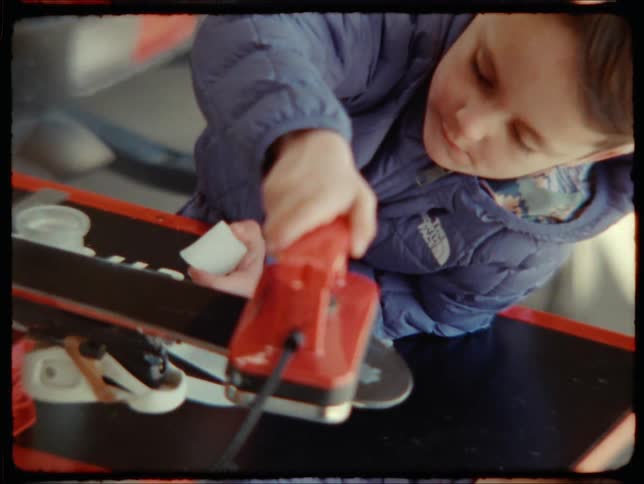 A little boy playing with a toy iron