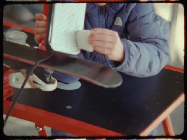 A childs hands scraping a white object in a machine