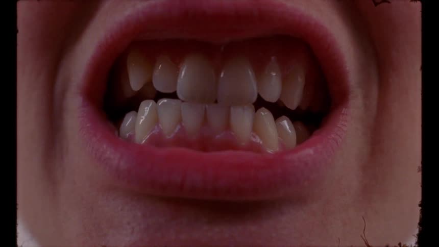A persons mouth opens and closes showing their teeth and tongue