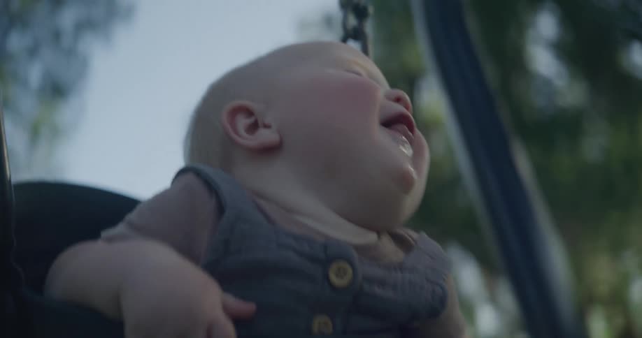 Portrait of a baby having fun on a swing