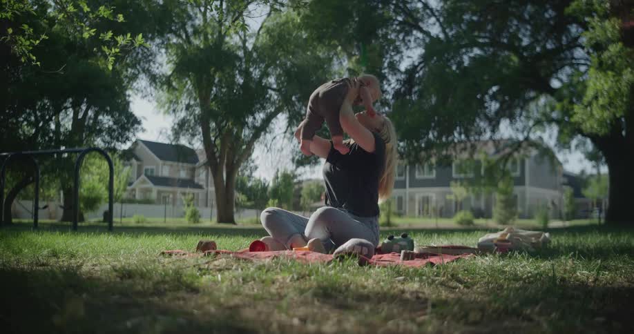 Mother and son have fun in a park on a sunny morning
