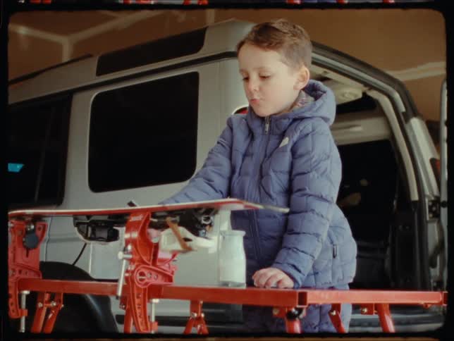 Boy playing with tools in the garage at home