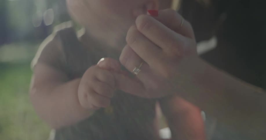 A mother holding her baby as they look around the surrounding