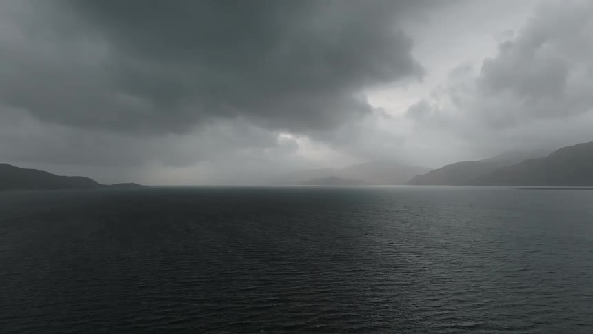 A large body of water is surrounded by mountainous shorelines