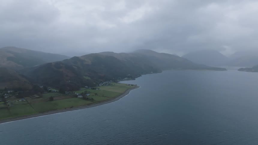 Fog hangs over the rural shore