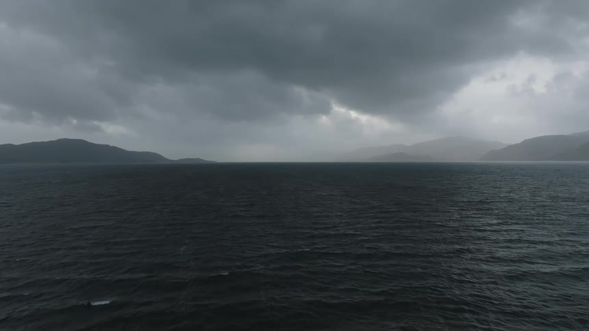 Heavy fog is over the mountains by the shore