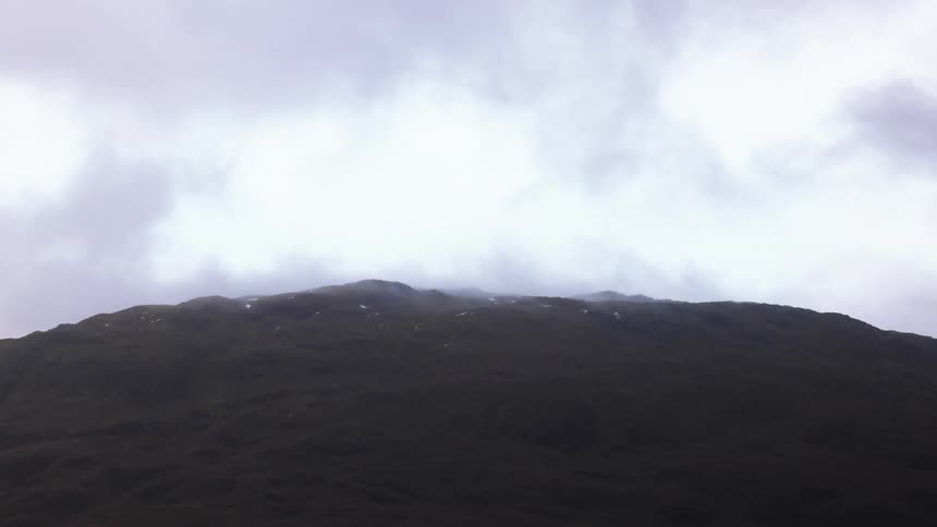 On top the mountain is covered by mist