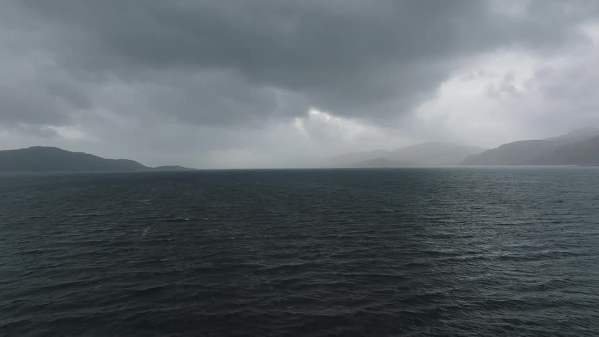 On a cloudy evening in the ocean with mountain nearby